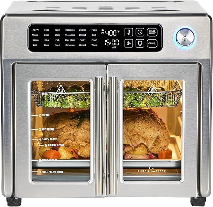 Emeril Lagasse 26-quart air fryer toaster oven combo with French doors, stainless steel finish, and multiple cooking functions, showing food inside.