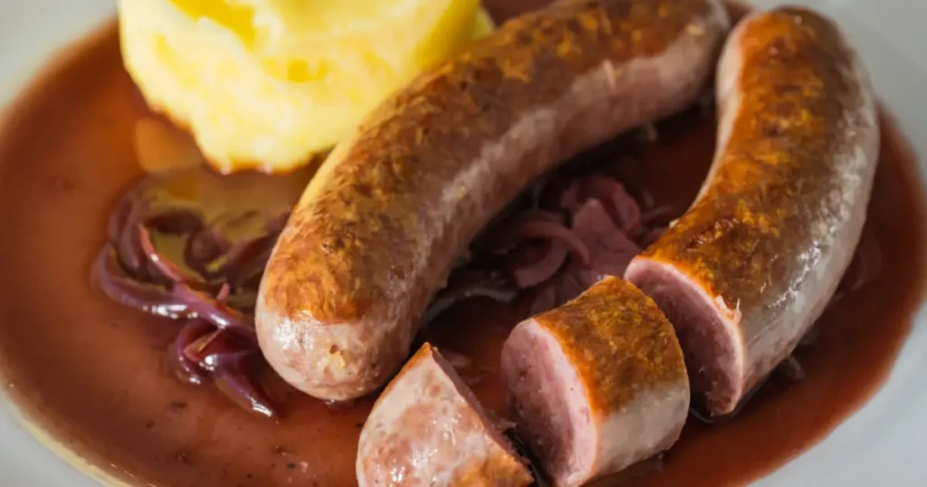 Plate of homemade venison sausage paired with sunny-side-up eggs, served as a hearty and nutritious breakfast