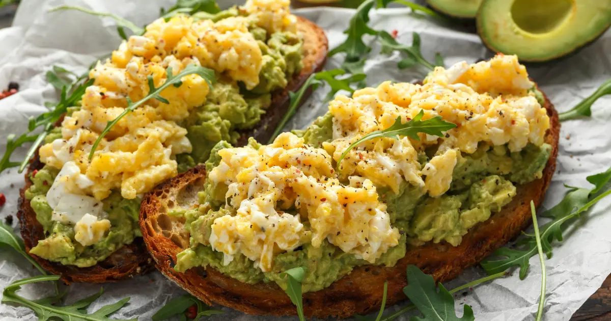 Sourdough toast topped with sliced avocado and a sunny-side-up egg