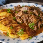 A plate of leftover pot beef roast served with golden potato slices.